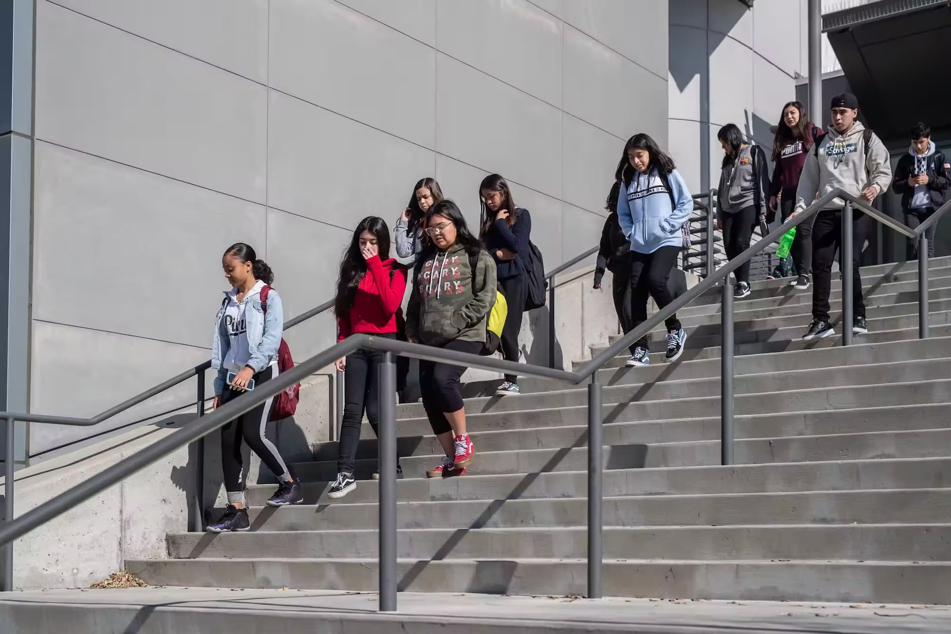 Students walking down stairs outside a college building